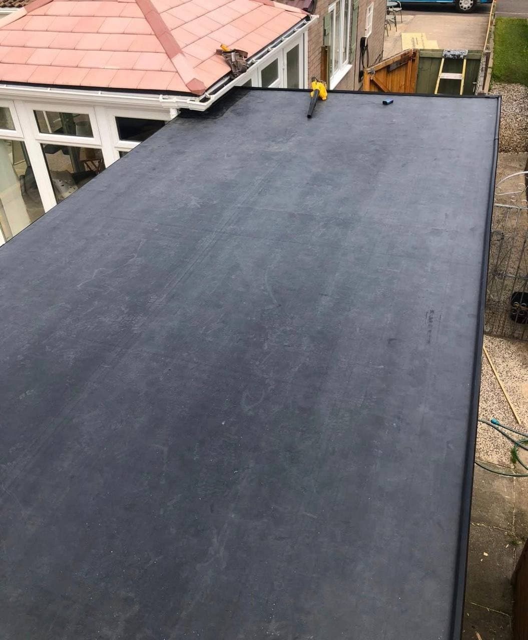 A finished single-ply membrane flat roof, with an edge trim run all the way round