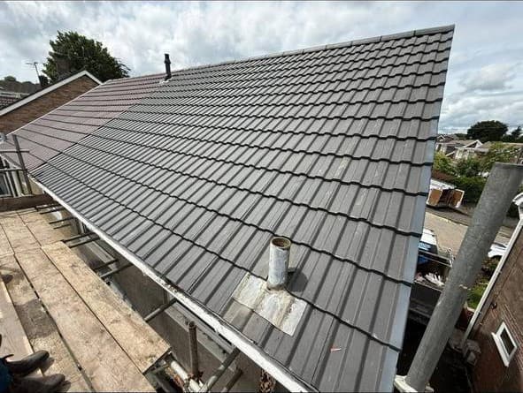 A finished hipped reroof with new fascia and gutter, and a lead tray dressed around the soil vent pipe